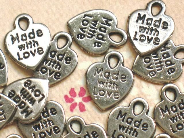 Word Made with Love is printed on both sides of charm